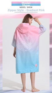 Detail view of pink and blue gradient hooded beach towel poncho with palm tree print
