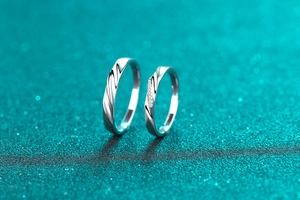 Détail macro de bagues de couple en argent 925 avec design torsadé et pierre de moissanite