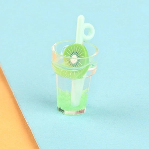 Macro view of a miniature kiwi drink charm with green resin slices and a tiny straw