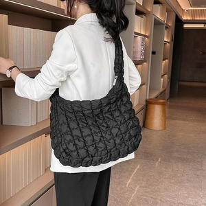 Quilted black hobo bag with cloud-like texture and soft wide shoulder strap for women