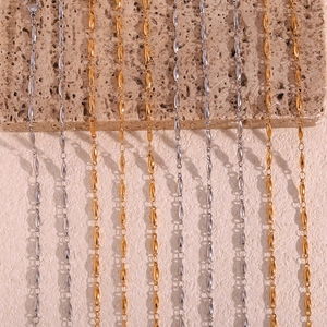 Detail of 18K gold and silver plated stainless steel chains with oval link texture