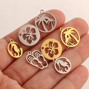 Handcrafted stainless steel tropical ocean pendants featuring seahorse and palm tree motifs