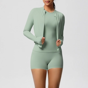 Close-up of mint green yoga set featuring long sleeve zip jacket and high waist shorts