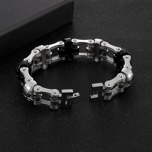 Detailed macro view of heavy metal biker chain bracelet with skulls and folding clasp