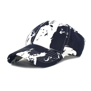 Detail shot of a baseball cap featuring black and white abstract map patterns and stitching
