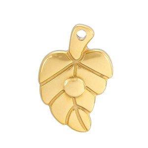Close-up of a polished golden leaf pendant with a top hole for jewelry making