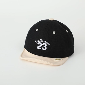 Detail view of baby baseball cap with Est. Number 23 embroidery and yellow brand tag