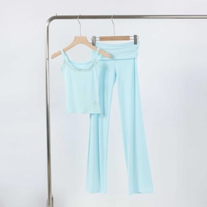 Detail of light blue loungewear set with lace trim camisole and flared trousers
