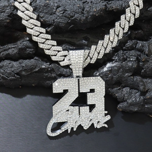 Iced out silver Cuban chain with number 23 pendant featuring sparkling crystals on rock