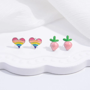 Detail of S925 silver studs featuring rainbow heart and pink carrot enamel designs