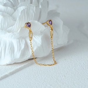 Detail of s925 silver gold tassel earrings with purple heart crystals and zircon stones