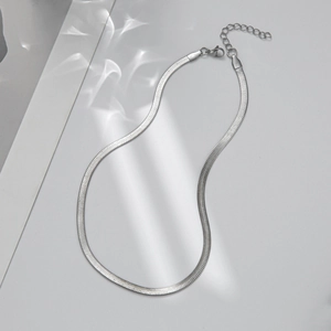 Detailed view of silver flat snake bone chain with lobster clasp and extension link