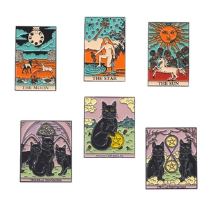Macro view of six enamel tarot card pins featuring The Sun, Moon, Star, and black cat designs