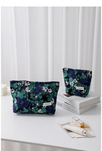 Macro detail of French vintage floral jacquard makeup bag set with premium textures