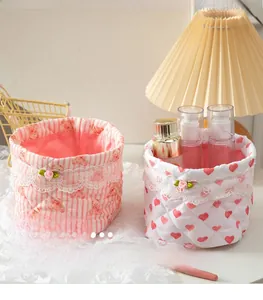 Detail of quilted desktop storage baskets with cute bear and heart patterns and lace trim