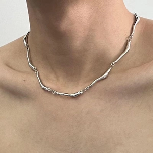 Silver irregular wave chain necklace with minimalist organic design for a modern edgy look
