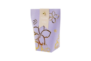 Close-up of lilac gift box with gold floral patterns and Thank You fold tag detail