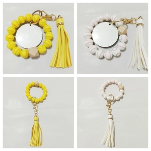 Detail of baseball silicone bead wristlet with yellow tassel and metal hook buckle