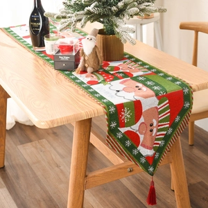 Christmas knitted table runner featuring Santa Claus and snowflakes with red tassels