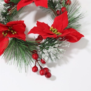 Detail of red poinsettia, green pine needles and berries for Christmas wreath