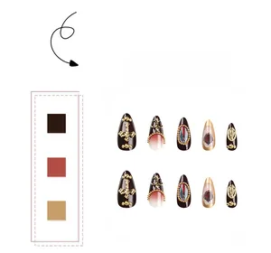 Detail of gothic stiletto press-on nails with golden cross and relief patterns