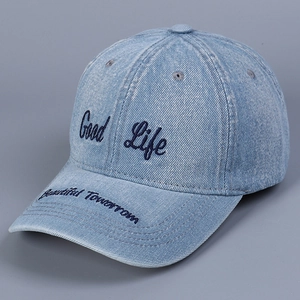 Detail of embroidered 'Good Life' and 'Beautiful Tomorrow' on washed blue denim baseball cap