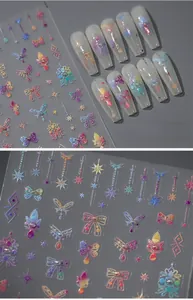 Detailed macro of 5D laser gradient nail stickers with bows and stars on long fake nails