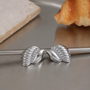 Detail view of leaf shaped silver steel earrings with fine textured vein patterns