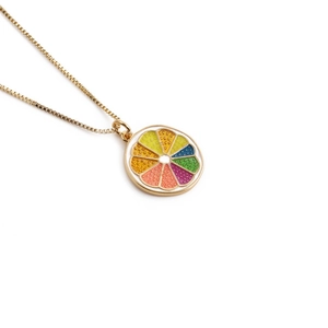 Gold plated copper necklace featuring a vibrant colorful citrus fruit slice pendant