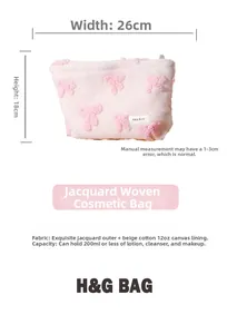 Detail view of pink plush cosmetic bag with bow texture and cotton lining, size 26x18cm