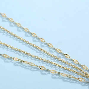 Detail of golden lip chain and O-ring chain mixture with polished metallic texture