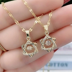 Golden hexagram necklace with sparkling dancing stone and shimmering cubic zirconia
