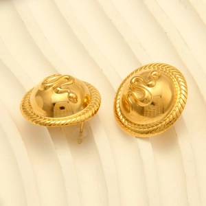 Detail of vintage 18k gold plated snake embossed round stud earrings on white pedestal