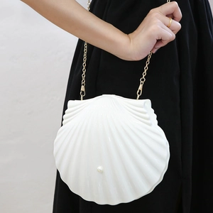 White shell-shaped handbag with pearl decor and golden chain strap for evening wear