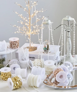 Close-up of pearl bead chain spools in gold and silver for Christmas tree decoration