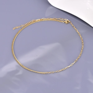 Detail of 18K gold-plated asymmetrical necklace with paperclip and twisted chain links
