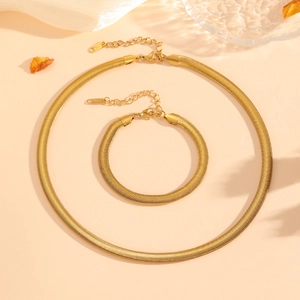 Close-up of golden stainless steel flat snake bone chain set with S.STEEL engraved tag