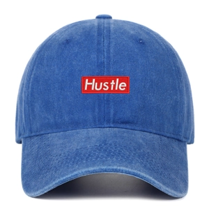 Detailed macro of vintage washed navy cotton baseball cap with red Hustle embroidery