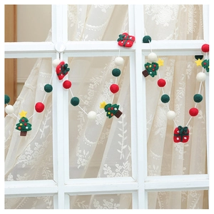 Close-up of wool felt Christmas garland with reindeer, pine trees, and colorful ornaments