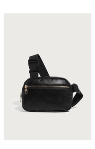 Detail of black lychee texture PU leather waist bag with golden zippers and strap