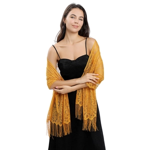 Close-up of yellow hollow lace shawl with fringe details for evening party dress