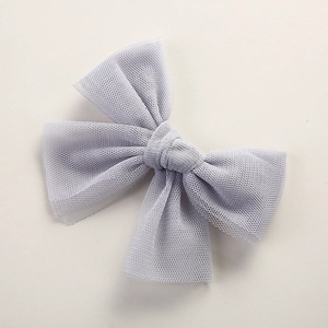 Detailed close-up of a grey tulle mesh butterfly hair bow clip for girls