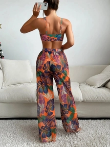 Back view of tropical print bikini set featuring mesh pants in vibrant orange colors