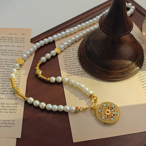 Elegant pearl necklace with hollow gold pendant on vintage book background