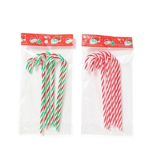 Detail of candy cane Christmas tree hanging ornaments in red white and green spiral patterns
