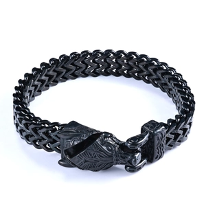 Close-up of black stainless steel woven chain bracelet with vintage wolf head clasp