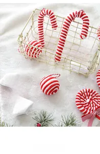 Detailed view of red and white velvet Christmas ornaments on a plush white surface