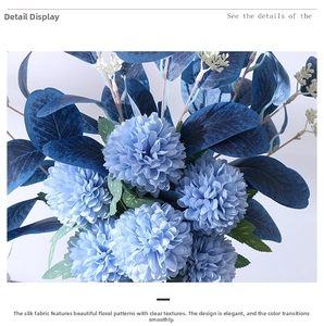 Detail of blue gradient silk chrysanthemum petals and textured faux eucalyptus leaves
