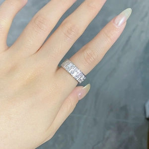Macro shot of S925 sterling silver eternity band featuring baguette cut zircons on finger