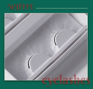 Detailed macro view of white faux mink eyelashes showing fiber texture and volume